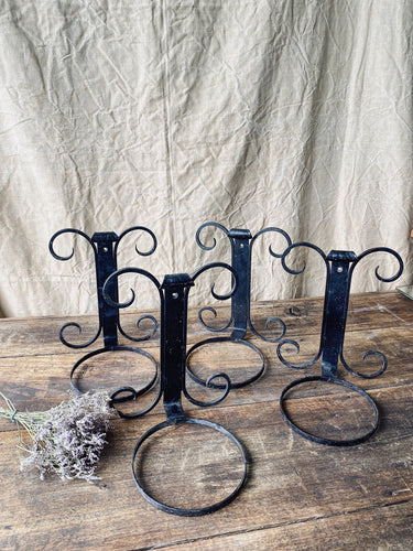 Black wrought iron wall mounted plant pot holder