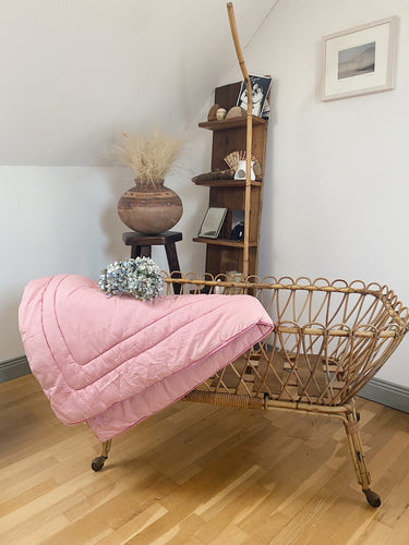 Vintage French rattan cradle on castors