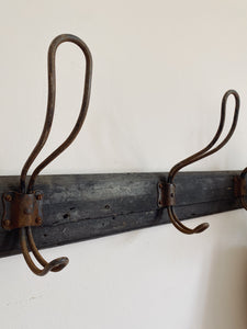 Vintage French row of school coat pegs on a wood plank